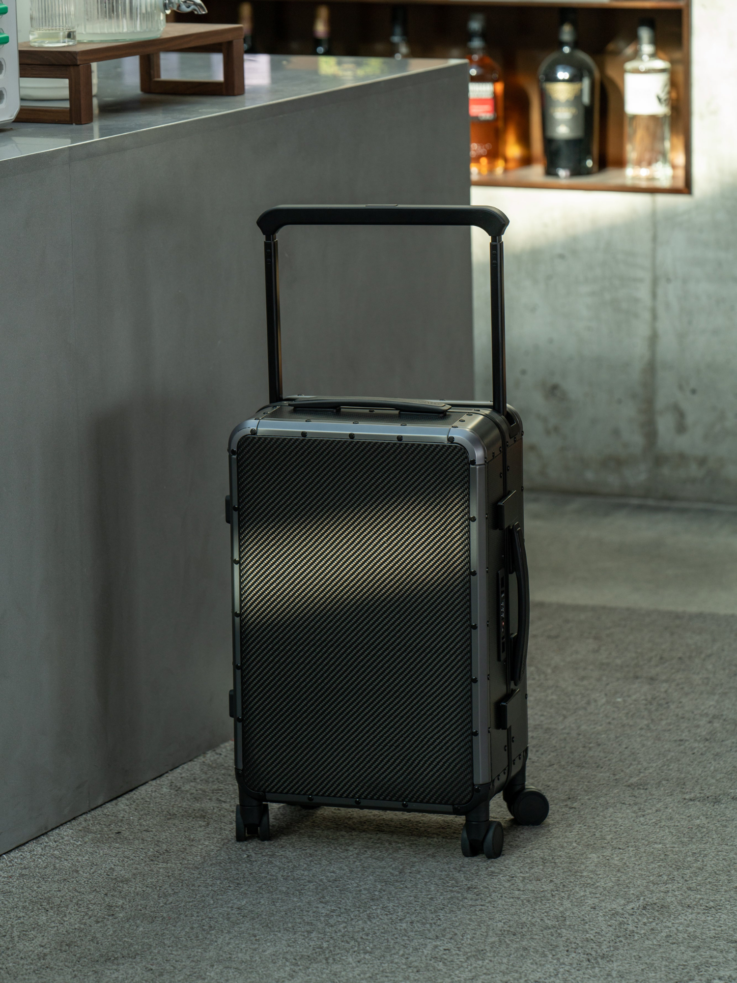 Premium black carbon suitcase with a sleek design, lightweight construction, and durable finish for luxury travel